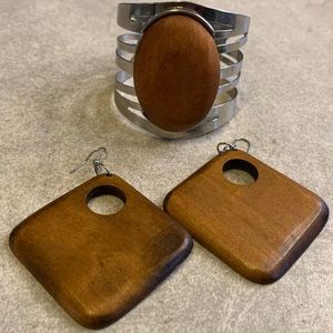 Silver bracelet with a wood pendant and wood earrings.